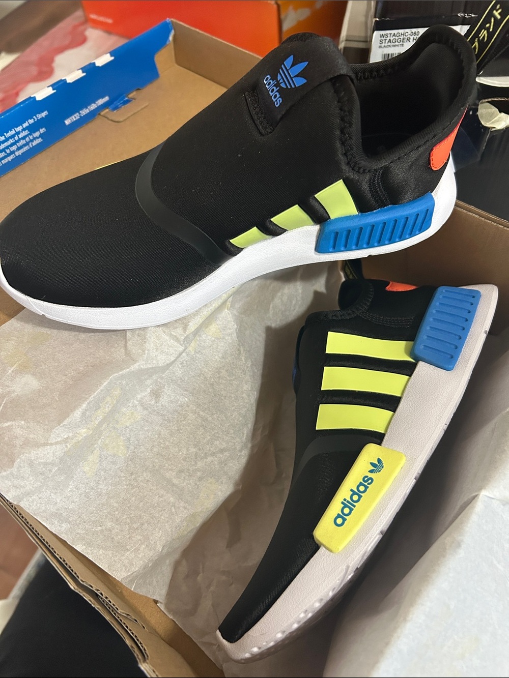 adidas Kids Black Slip-On Sneakers with Neon Yellow Stripes and Blue Accents